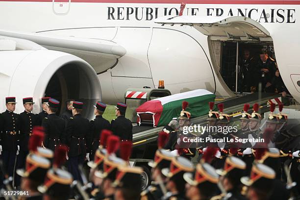 The coffin of former Palestinian leader Yasser Aarfat is loaded into an awaiting aircraft at the Villacoublay Military Airport on its way to Cairo on...