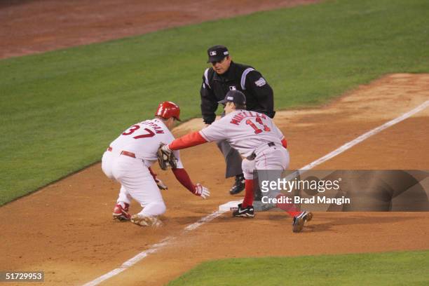 Third baseman Bill Mueller of the Boston Red Sox tags out Jeff Suppan of the St. Louis Cardinals at third base during game three of the 2004 World...