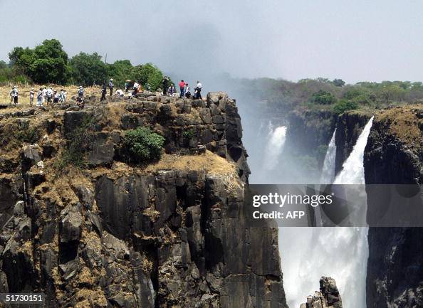 Tourists view the Victoria Falls in Livi Tourists view the Victoria Falls in Livi