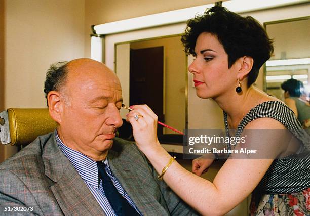 American lawyer, politician, political commentator, and past mayor of New York City, Ed Koch has make-up applied before appearing on telelvision,...