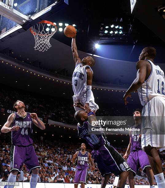 Steve Francis of the Orlando Magic attempts to dunk over Erick Strickland of the Milwaukee Bucks during the game at TD Waterhouse Centre on November...