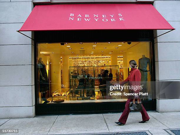 Pedestrian passes Barneys New York November 11, 2004 in New York City. The Jones Apparel Group has announced a deal to buy Barneys, the clothing...