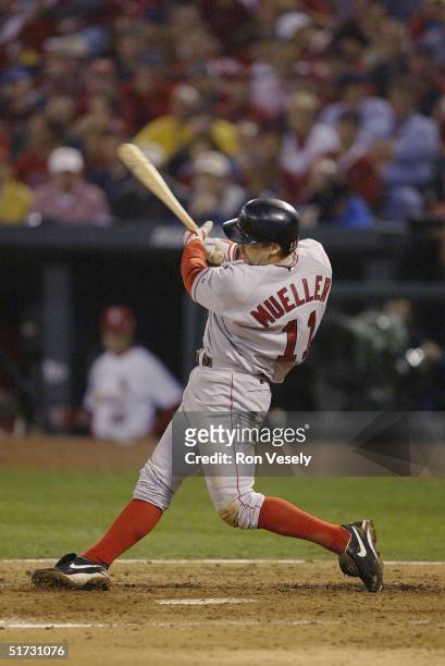 Bill Mueller of the Boston Red Sox hits an RBI single in the fifth inning during game three of the 2004 World Series against the St. Louis Cardinals...