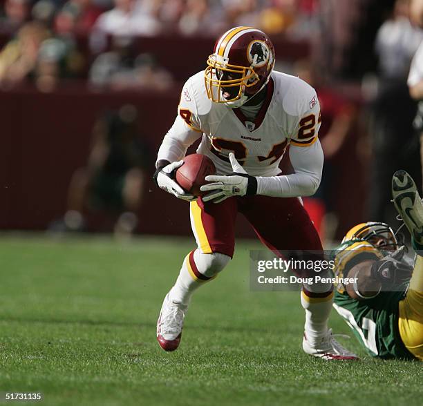 Shawn Springs of the Washington Redskins runs the ball against the Green Bay Packers at FedEx Field on October 31, 2004 in Landover, Maryland. The...