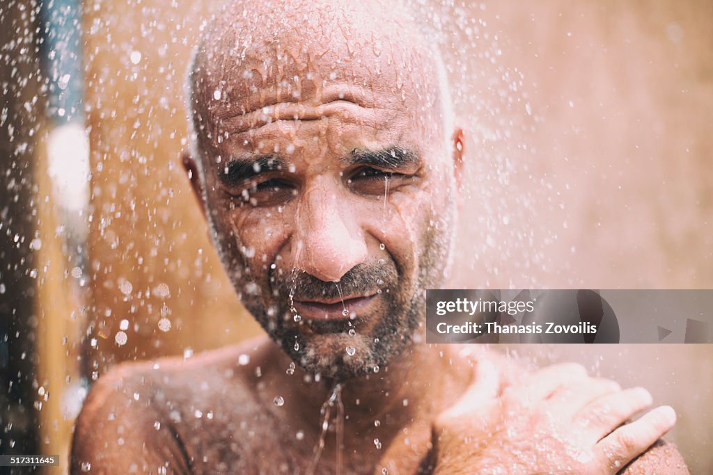 Portrait of a man under a shower