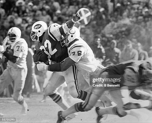 Running back Emerson Boozer of the New York Jets gets tackled from by a Baltimore Colts defensive player during a game circa 1966-1975.