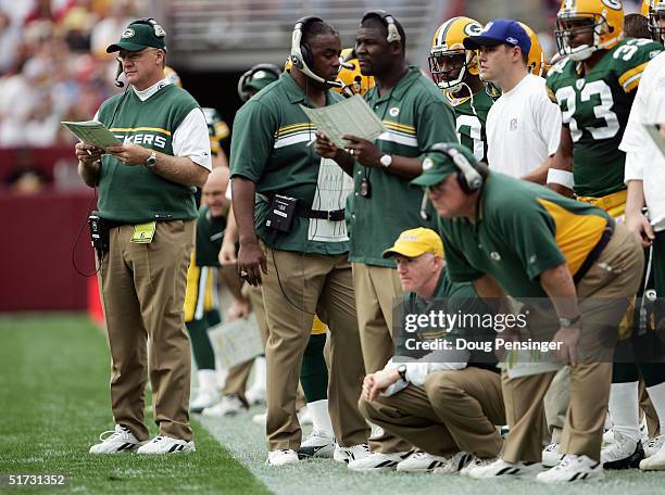 Head Coach Mike Sherman of the Green Bay Packers, far left, and his coaching staff watch from the sideline during the game against the Washington...