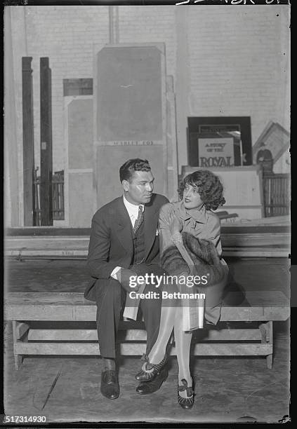 Photo shows Jack Dempsey, former heavyweight champion, and his wife, Estelle Taylor, movie star, going over the script of parts in the play in which...