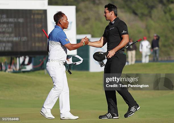 Jason Day of Australia greets Thongchai Jaidee of Thailand on the 15th green after Day won their match 5&3 during the second round of the World Golf...