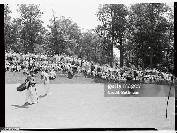 Jimmy Thompson of Shwanee-on-Delaware as he sank a put on the second hole as Dick Metz of Chicago, stands by during the final round of the Western...