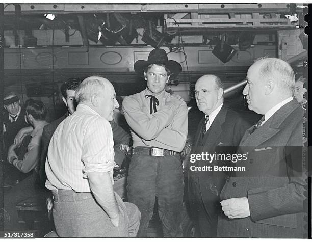 Cecil B. DeMille, Joel McCrea, J. C. Gale, Assistant to the President of the Union Pacific, , are shown on the set of Union Pacific, Paramount's...