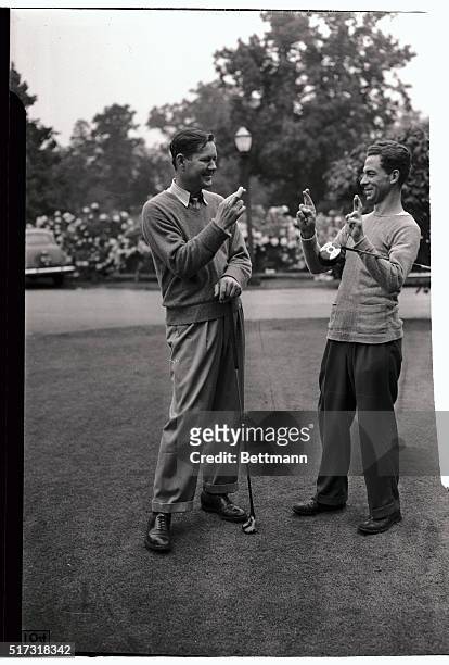 Byron Nelson , of Toledo, Ohio, and Eddie Kirk, of Framington, Michigan, both cross their fingers for luck in their match tomorrow against each other...