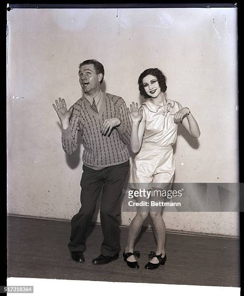 Couple demonstates the national dance craze, the Charleston. Undated photograph circa 1920.