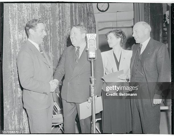 Norman Siegel, Cleveland Press Columnist, , is shown being greeted to Hollywood by Charles Laughton. Looking on are Else Lanchester, , and Cecil D....