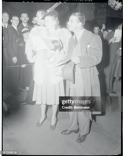 Director Al Hall, and actress Lucille Ball are shown arriving at the Hollywood Pantages Theater for a preview of My Little Chickadee."