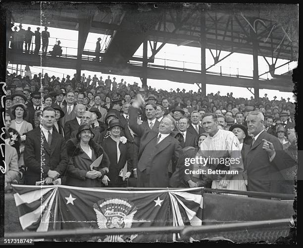 Herbert Hoover throwing out the 1st ball opening the 1931 baseball season. Game was between the Washington Senators and the Philadelphia A's. Man in...