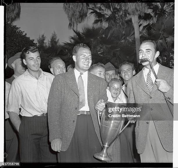 Sammy Snead , of White Sulphur Springs, West Virginia, kisses his lucky iron after carding a magnificent six-under-par 64 in the final 18 holes to...