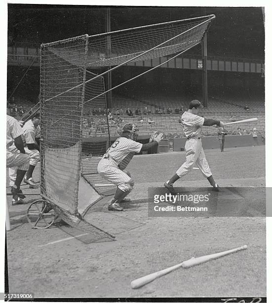 Slugging outfielder Joe DiMaggio of the New York Yankees, whose leg injury is expected to keep him out of action for a month, shown at batting...