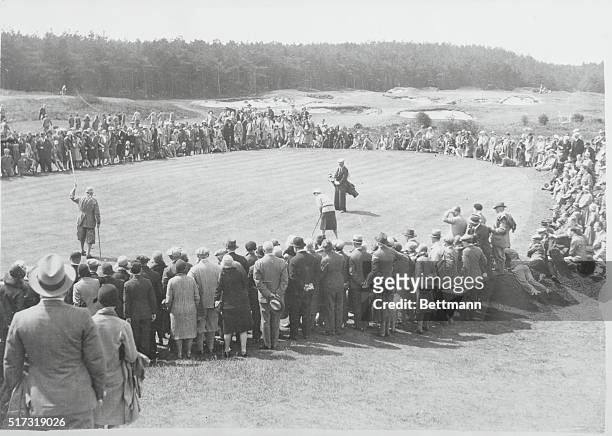 Formby, England: Miss Glenna Collett, American champion, putting on 13th green of the Women's Open Golf Championship just before match went to Diana...
