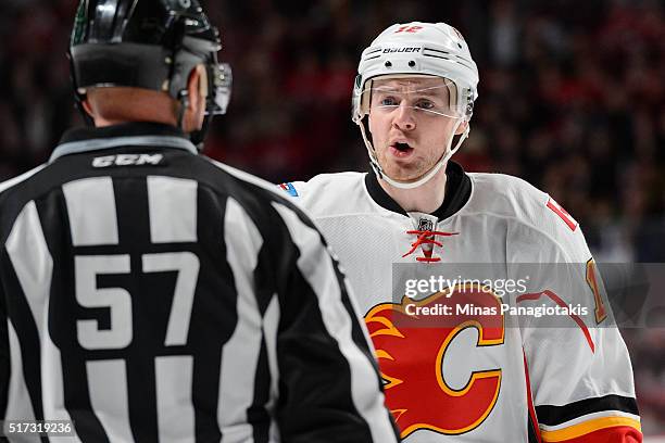 Matt Stajan of the Calgary Flames speaks to linesman Jay Sharrers during the NHL game against the Montreal Canadiens at the Bell Centre on March 20,...