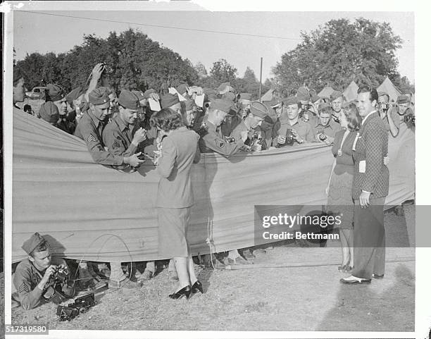 Claudette Colbert , gave away her autograph, while Joan Blondell and Dick Powell posed for the boys with cameras. The conclusion was reached, after...