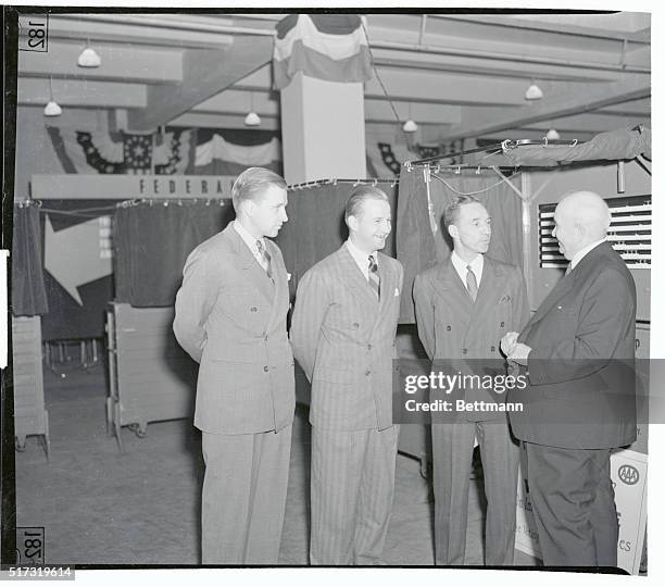 Fords at automobile show...New York City: Henry Ford II, Benson Ford and Edsel Ford receive instructions from Thomas P. Henry, president of the AAA,...