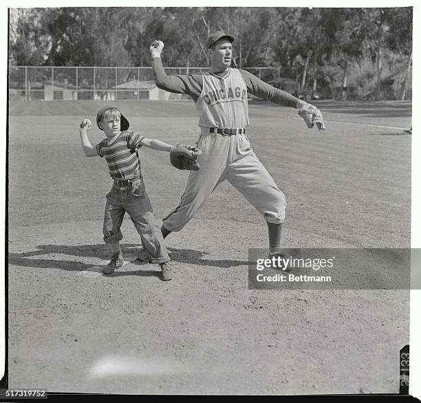 At the Chicago Cub's spring training camp here on Catalina Island Dizzy Dean demonstrates to 8 1\2 year old "Scooter" Hansen how he "fogs 'em in".