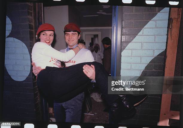St. Louis: Guardian Angels founder Curtis Sliwa carries his bride, Lisa, across the threshold at their $100 a month apartment in the crime ridden...