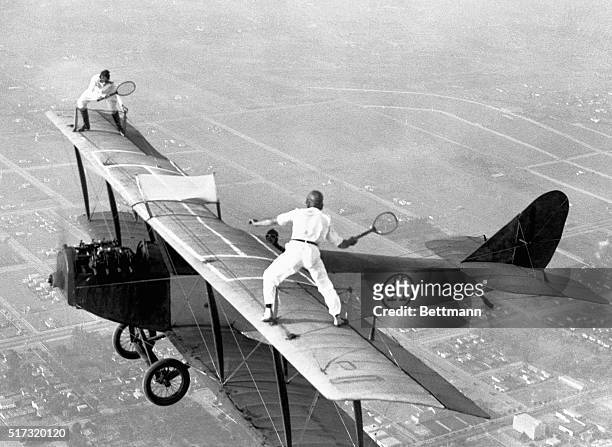 Gladys Roy, who gets her fun out of doing unusual things with airplanes, also likes to play tennis. Ivan Unger is her opponent. Frank Tomac is the...