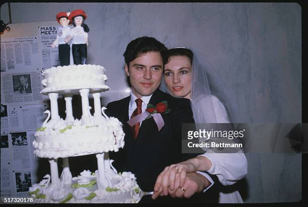 New York: Curtis Shim, left, founder of the Guardian Angles crime patrols, and his bride Lisa Evans cut the cake after their marriage. Evers, a black...
