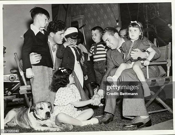 Vittorio Mussolini, son of Italy's dictator who is here to study motion picture production technique, is shown being greeted by "Our Gang" when he...