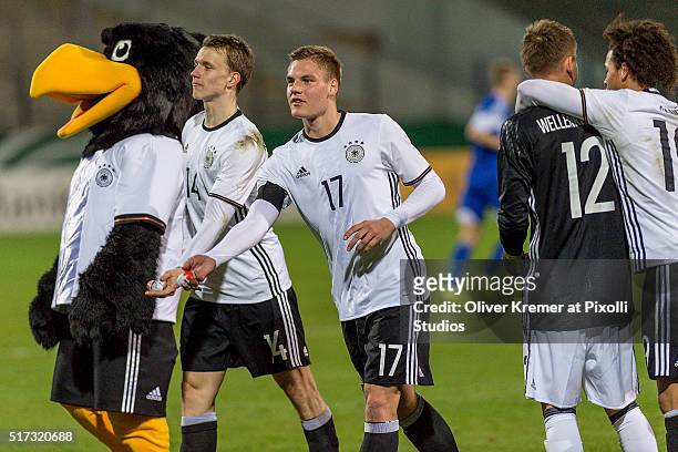 Defense Lukas Klostermann of Germany and Midfielder Max Christiansen of Germany throw chocolate eggs into the audience at Frankfurter...