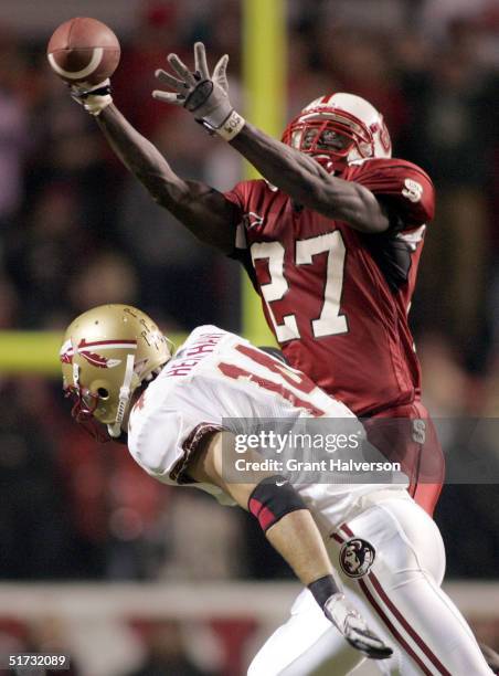Troy Graham of the North Carolina State Wolfpack breaks up a pass intended for Matt Henshaw of the Florida State Seminoles during an ACC game on...