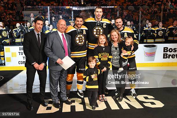 Chris Kelly, Patrice Bergeron, Zdeno Chara and David Krejci of the Boston Bruins present their head coach Claude Julien and his family with a trip to...