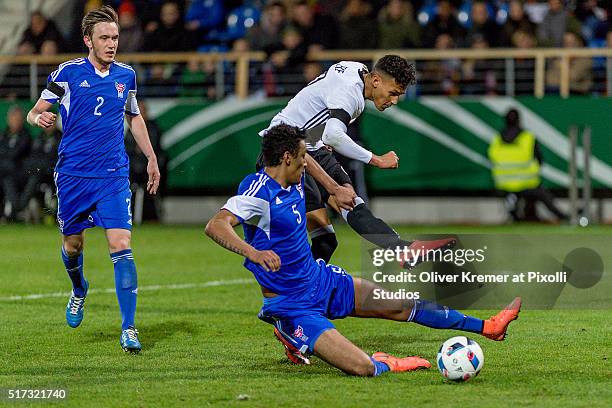 Forward Davie Selke of Germany trying to score while Sonni Ragnar Nattestad of Faroe Islands try to the defend the ball at Frankfurter...