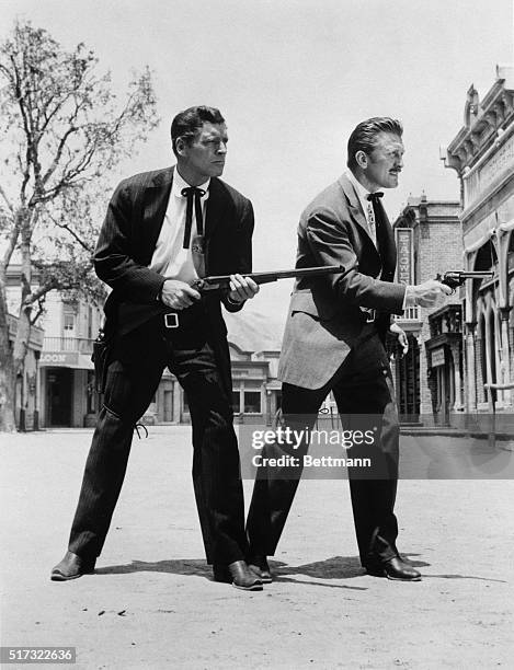 Burt Lancaster and Kirk Douglas in a scene from the film, "Gunfight at the OK Corral." Burt has his shotgun drawn while Kirk draws his pistol. They...