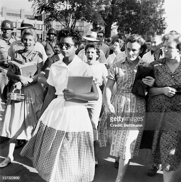 Elizabeth Eckford ignores the hostile screams and stares of fellow students on her first day of school, 6th September 1957. She was one of the nine...