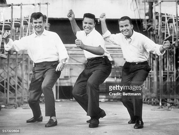 Chubby Checker leads Conway Twitty and Dick Clark through the dance the Twist, 7th September 1960.