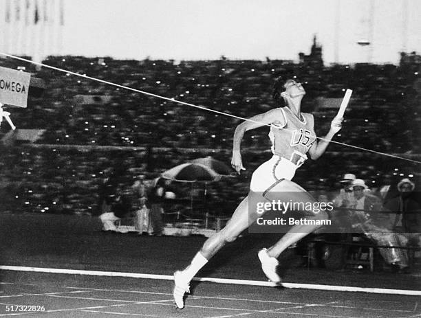 Running the anchor leg, American Wilma Rudolph crosses the finish line to win the women's 400-meter relay at the 1960 Summer Olympics in Rome. The...