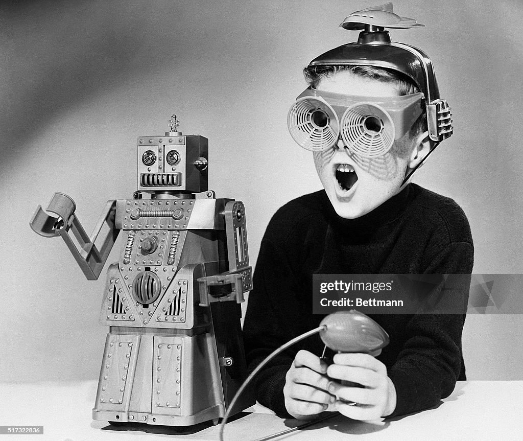 A boy wearing a futuristic space helmet and goggles demonstrates