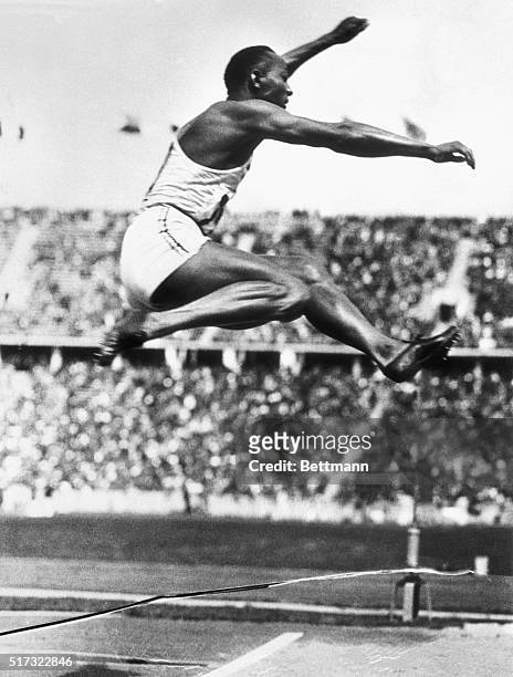 American track athlete Jesse Owens makes the long jump that set an Olympic record in Berlin at the 1936 Olympic Games. His performance at the Games...