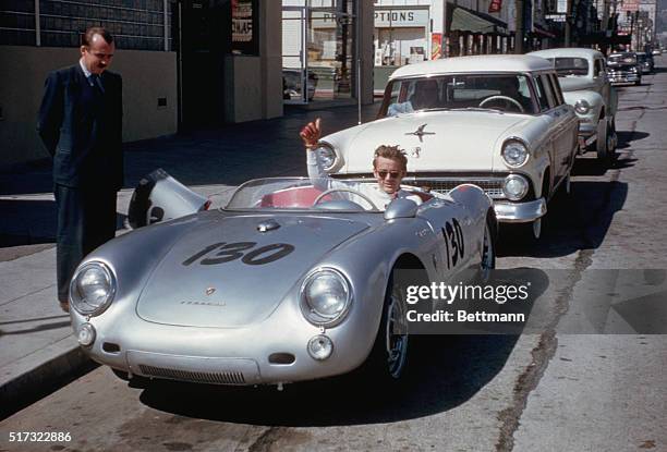 Actor James Dean gives a thumbs-up sign from his Porsche 550 Spyder, the Little Bastard, while parked on Vine Street in Hollywood. Dean, who had...