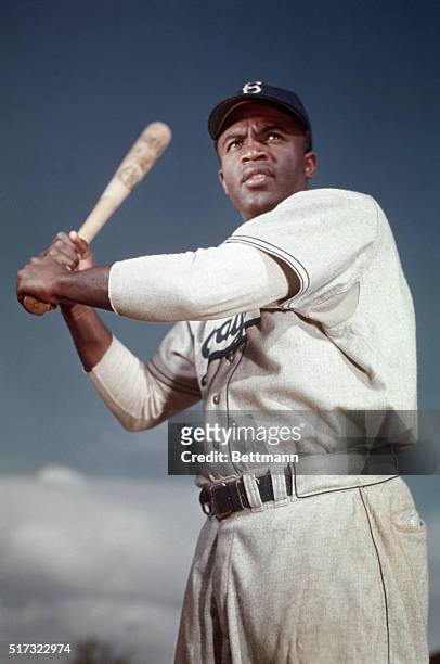 Brooklyn Dodger Jackie Robinson poses in his batting stance. Robinson broke baseball's color barrier when he joined the Dodgers in April 1947, going...
