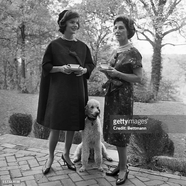 Jackie Kennedy stands with her mother, Janet Lee Auchincloss and a French poodle. Kennedy is the wife of presidential hopeful Senator Kennedy, and is...