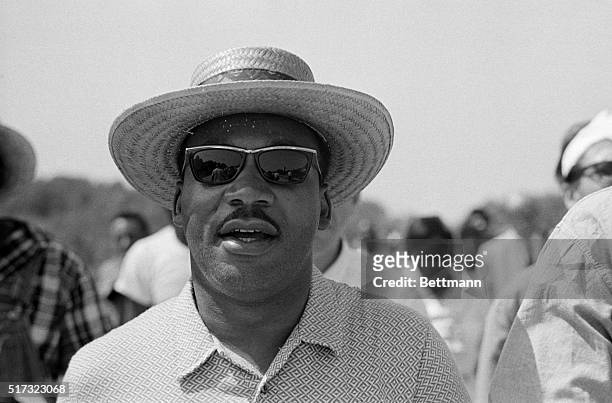 Martin Luther King, Jr., wearing a hat and sunglasses calls out "All right, all right, we're gonna march, we're gonna march straight south" as he...