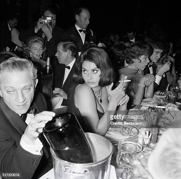 Paris: Looking very much like the temptress she plays in the movies, Italian film star Sophia Loren sits at her table in the famous Lido night club...