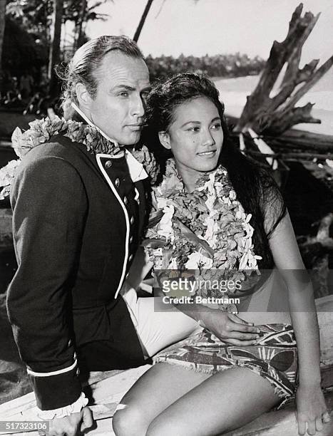 Marlon Brando, dressed as Fletcher Christian, beside Tarita Teriipia, who plays Maimiti in the 1961 production of Mutiny On The Bounty. Brando would...