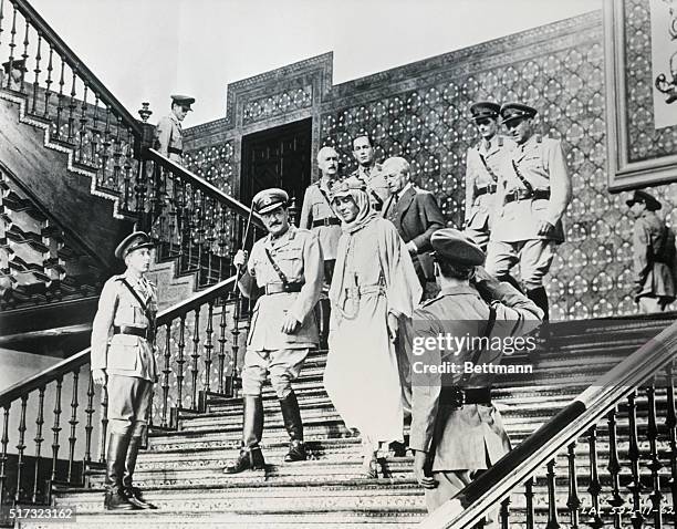 Lawrence "of Arabia" descends the stairs at G.H.Q. With his commander General Allenby , Mr. Dryden of the Foreign Office , and Colonel Harry Brighton...