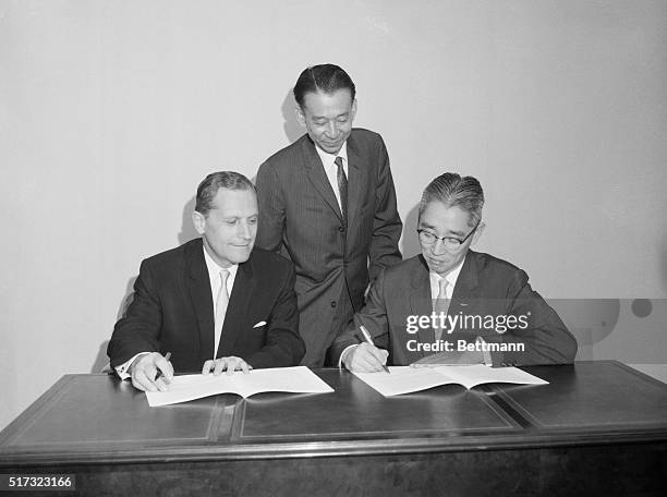 Akio Morita, executive vice president of Sony Corporation, signs documents covering the company's scheduled public offering in the United States of...