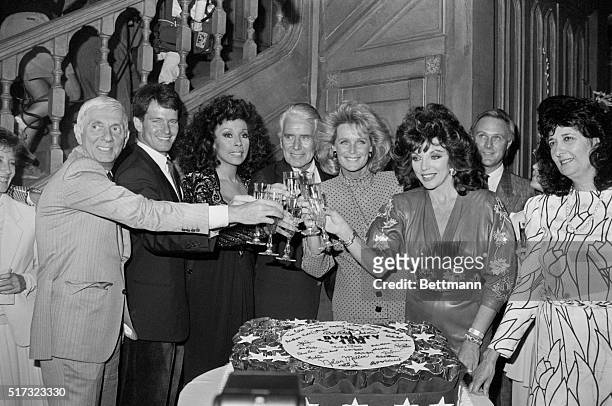 The actresses and actors join producer Aaron Spelling in toasting to the 150th episode of the television series "Dynasty" on September 23, 1986....